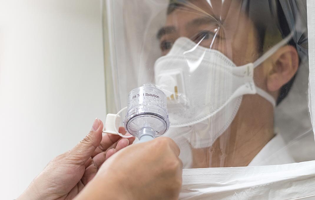 N95 mask fit testing session with certified technician using qualitative testing equipment