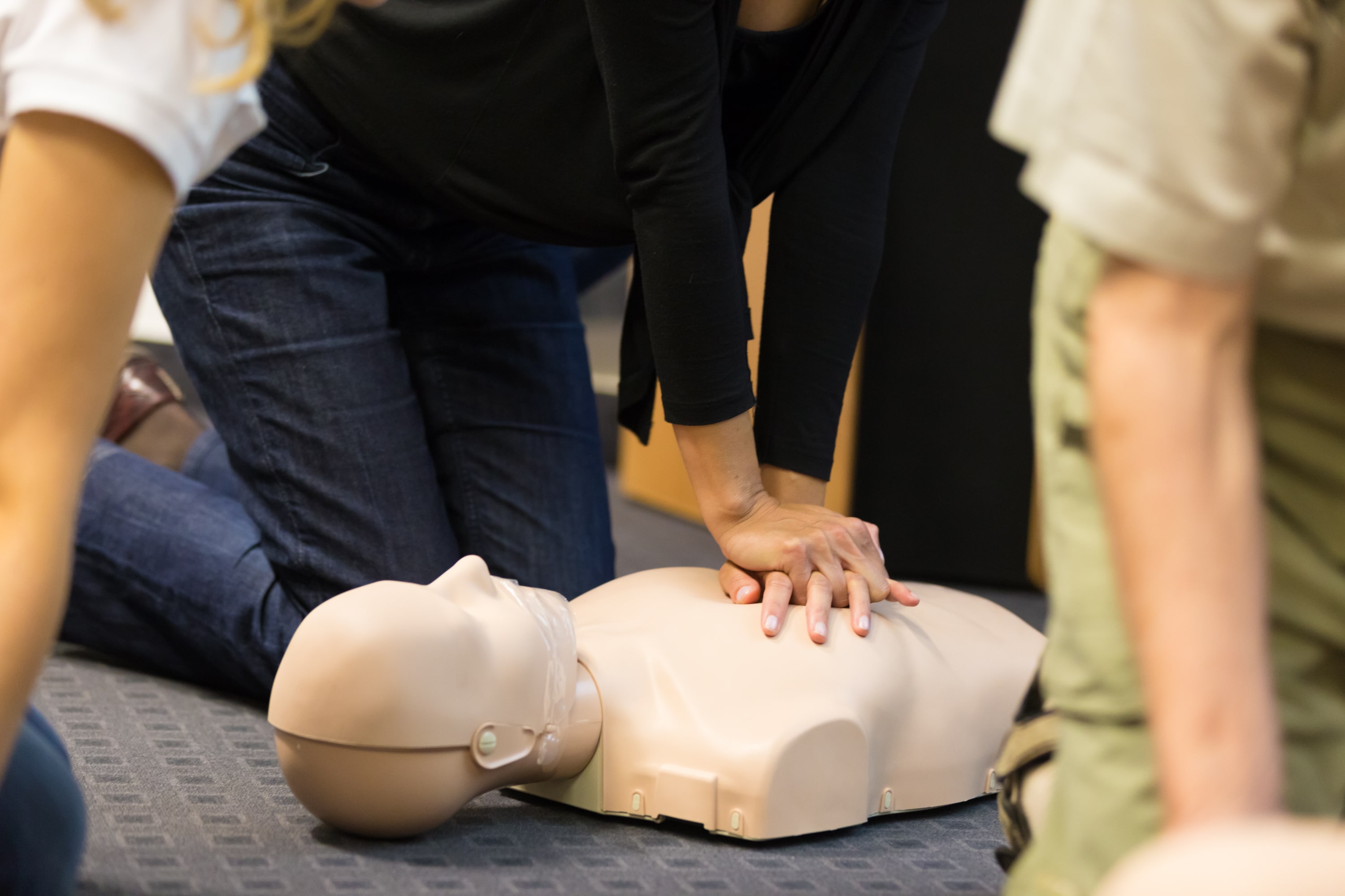 Emergency First Aid training session with instructor demonstrating emergency response techniques