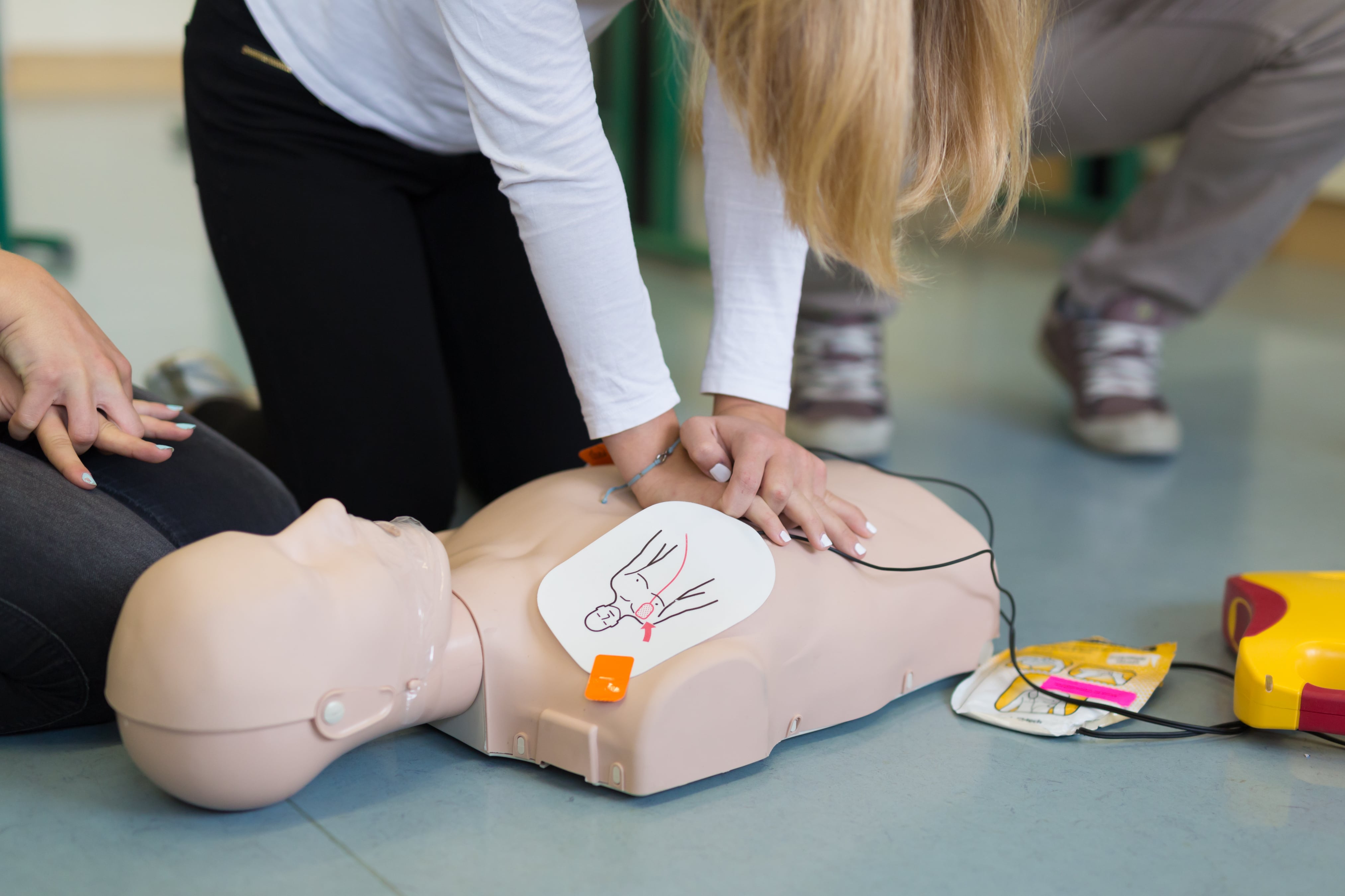 Standard First Aid training session with instructor demonstrating comprehensive emergency response techniques